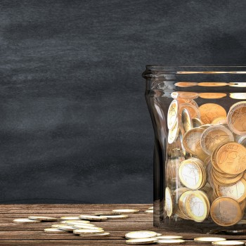 Mason jar full of coins. Financial saving metaphor.